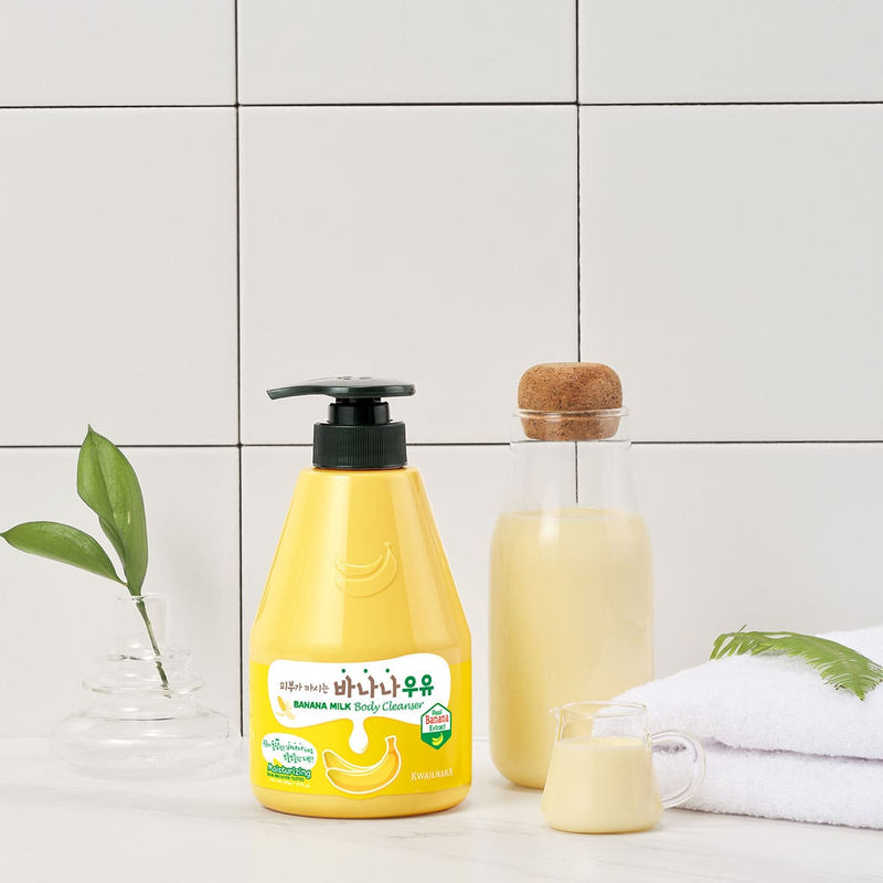 Kwailnara Banana Milk Body Cleanser bottle on a bright bathroom shelf, a K-beauty must-have with nourishing banana extract and milk protein for soft, hydrated skin.

