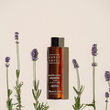 Shampoo bottle with lavender flowers on a beige background