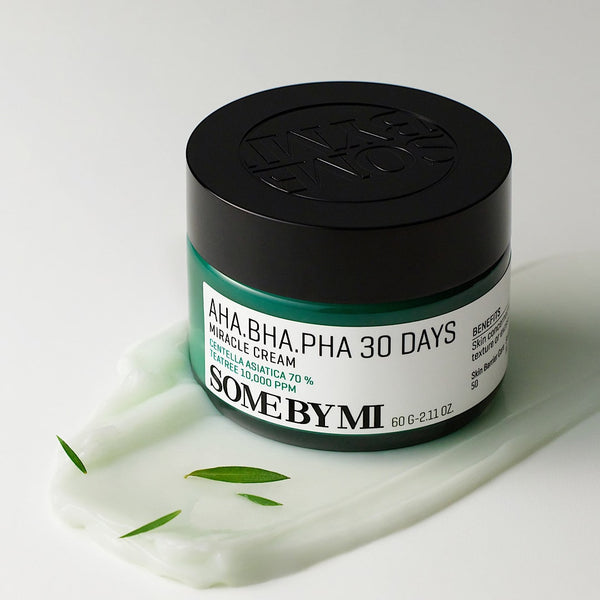 Close-up of SOME BY MI AHA.BHA.PHA 30 Days Miracle Cream, a Korean skincare product known for reducing acne, exfoliating dead skin cells, and minimising pores; features gentle exfoliants AHA, BHA, and PHA for clear and radiant skin in 30 days.
